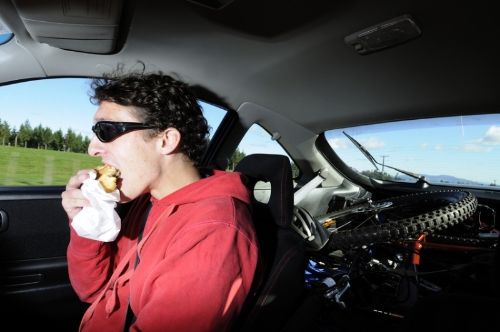 man driving and eating